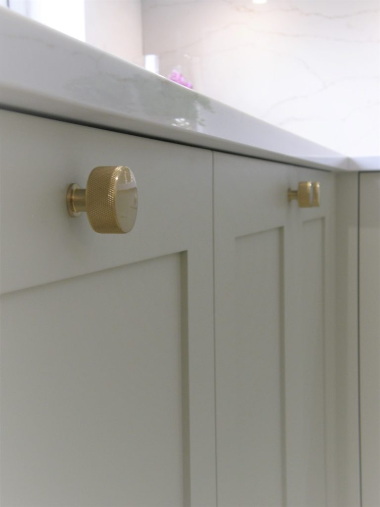 White Kitchen with brass accents.